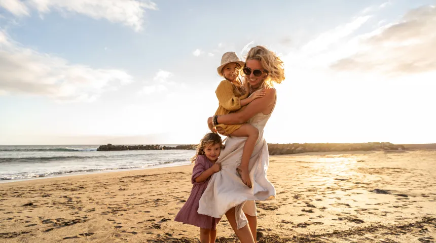 Mother and daughter enjoying together at the beach, family health and wellness