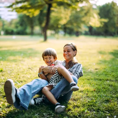 Father and son playing actively in the park, joint health and mobility